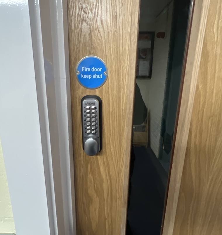 Keypad lock fitted to an office fire door, Croydon